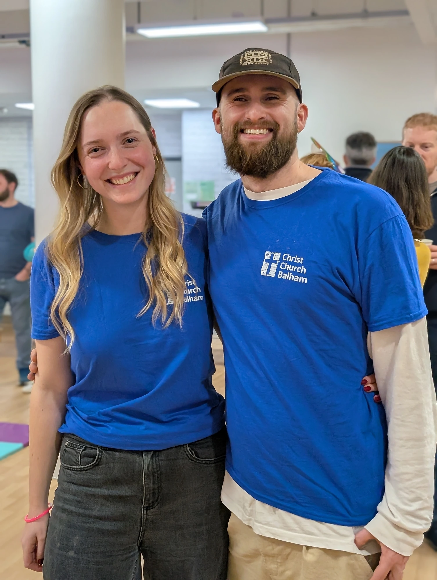 A couple from the Christ Church Balham welcome team in their church shirts